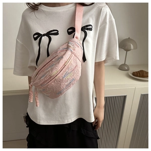 Close-up of pink textured jacquard crossbody bag with embroidery and woven zipper detail