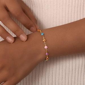 Close-up of woman wearing a colorful heart-shaped gold-plated stainless steel bracelet