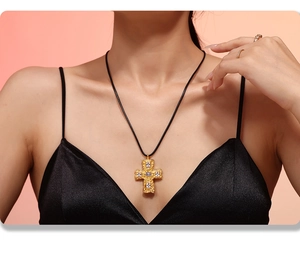 Detailed close-up of 18K gold plated hammer-textured cross necklace with crystal inlays