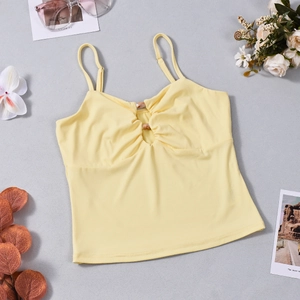 Detail of yellow cropped tank top with ruched bust and buckle on grey background