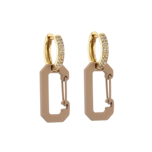 Detail of gold zircon hoop earrings with a matte brown geometric pin pendant charm
