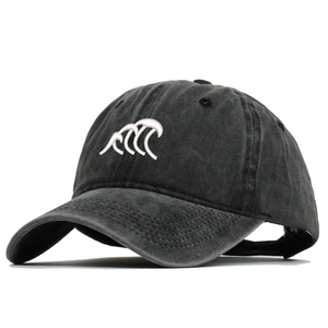 Detail of vintage washed black cotton denim baseball cap with white wave embroidery