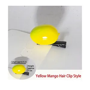 Detail of yellow mango sprout hair clip with dimensions showing 4cm length and metal clip