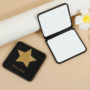 Mini folding double-sided makeup mirror with black square case and gold star design