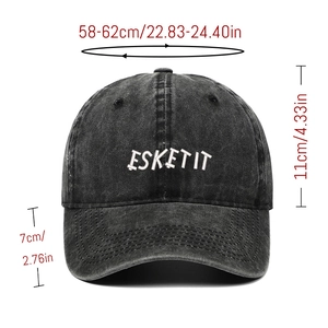 Detail of white ESKETIT embroidery on dark grey washed cotton baseball cap