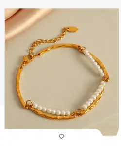 Detail of double-layer gold pearl bracelet with irregular hammered metal texture details
