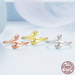 925 sterling silver hug ring set in gold, rose gold and silver colors on soft feathers