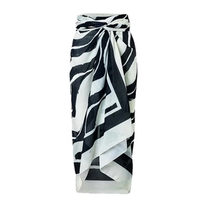 Elegant high-waisted wrap skirt featuring black and white zebra print and side tie knot