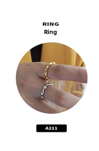 Detailed view of silver and gold rings featuring an irregular pebble chain link design