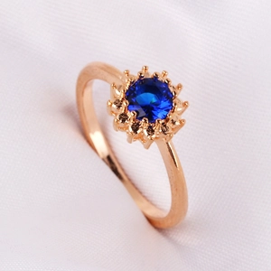 Elegant 18K gold plated ring with a deep blue round zircon in a floral setting