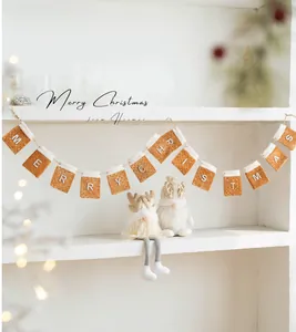 Detail of felt Merry Christmas banner with plush trim and two gnome dolls for festive decor