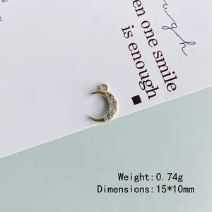 Macro shot of 15x10mm golden crescent moon pendant with rhinestones for DIY jewelry