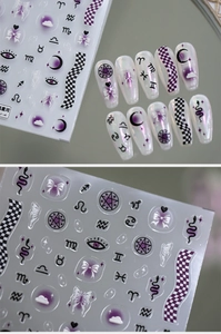Detail of purple Y2K nail stickers with moon and butterfly embossed patterns