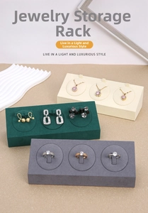Close-up of microfiber jewelry stands displaying necklaces and earrings in beige and green