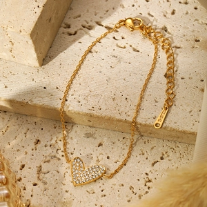 Detail of gold-plated stainless steel heart bracelet with micro-pave cubic zirconia stones