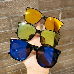 Detail of colorful reflective lenses and triple-dot rivets on children's sunglasses