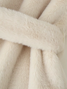 Detailed macro view of soft cream faux fur texture with elegant plush fiber sheen