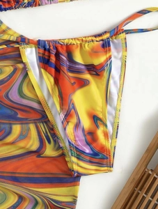 Detail of bikini bottom featuring vibrant marble swirl print and side tie strings