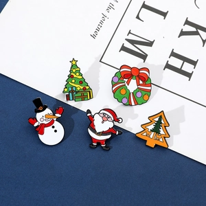 Detailed view of 5-piece set of colorful enamel Christmas pins with snowman and santa