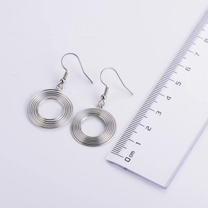 Detailed view of silver spring hoop earrings with a ruler showing exact size measurement