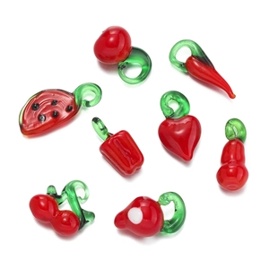 Detailed view of handmade glass fruit pendants including watermelon and chili shapes