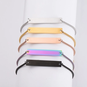Detail showing five color variants of stainless steel bar bracelets on display stand