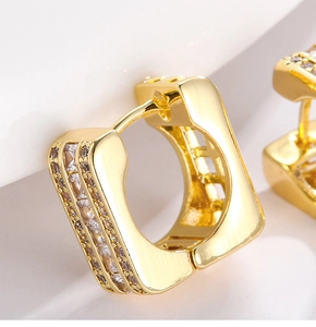 Macro shot of gold square hoop earrings with three rows of sparkling micro-pave zircons