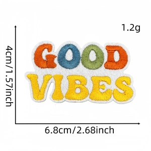 Macro detail of Good Vibes embroidered patch showing colorful needlework and fabric texture