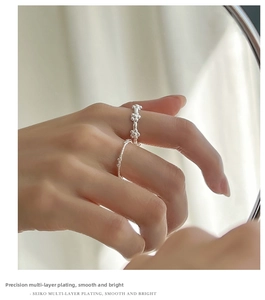 Close-up of hollow bow rings for women featuring multi-layer plating and polished finish