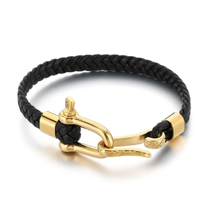 Mens black braided leather bracelet with golden horseshoe buckle and textured finish