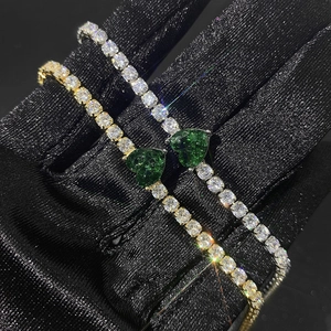 Bracciali tennis con cuore verde in finitura oro e argento ghiacciati
