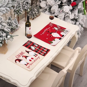 Christmas placemats featuring gnome patterns and Merry Christmas text on a holiday table