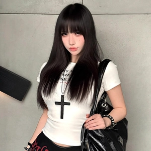 Close-up of a large black cross pendant necklace paired with a trendy white letter print T-shirt