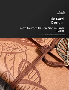 Close-up of vintage leather journal with leaf embossing and a bronze leaf metal pendant