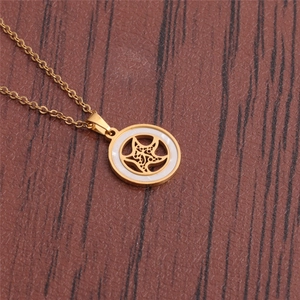 Minimalist gold starfish pendant necklace with a white inlay on a dark wooden background