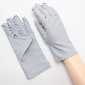 Detail of grey full-finger spandex gloves with wavy stitched cuffs on mannequin arm