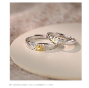 Macro detail of sun and moon couple rings in polished silver with gold relief
