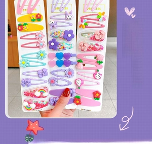 Close-up of assorted macaron-colored hair clips with floral and rainbow cartoon charms