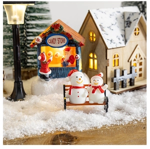 Cozy Christmas village scene with glowing wooden house, snowman family and candy store