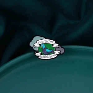 Detail of pigeon enamel pin featuring 'I WILL SHIT ON EVERYTHING YOU LOVE' slogan