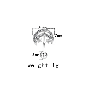 Macro detail of crescent moon and star eyebrow piercing with 8.5mm width and 1g weight