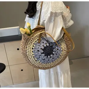Detail of colorful round paper rope straw bag with sunflower pattern and leather strap