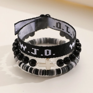 Detail of WWJD woven band, black bead cross bracelet, and grey heishi bead set