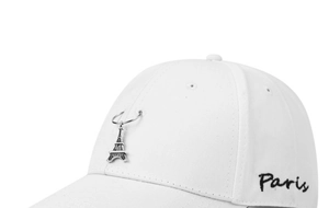 Detail of white cotton baseball cap featuring Paris embroidery and Eiffel Tower pendant