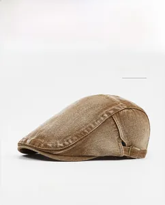 Detail view of khaki cotton newsboy cap with vintage texture and metal buckle adjustment