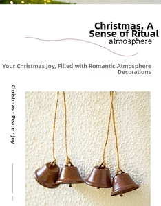 Detail of vintage brown metal Christmas bells with natural jute rope on beige wall