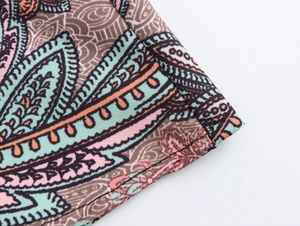 Macro shot of high-quality stitching and bohemian paisley print on the fabric edge