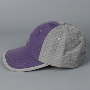 Detail view of quick-dry baseball cap with purple and grey grid texture and embroidery