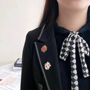Detail of creative heart organ enamel pins with floral motifs pinned on a black suit lapel