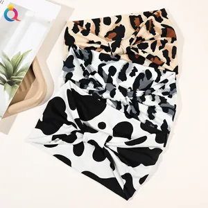 Detailed view of elastic leopard and cow print wide twisted headbands for women